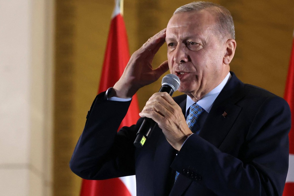 Turkish President Recep Tayyip Erdogan addresses his supporters in Ankara early on Monday after he secured another five years in power. Photo: AFP