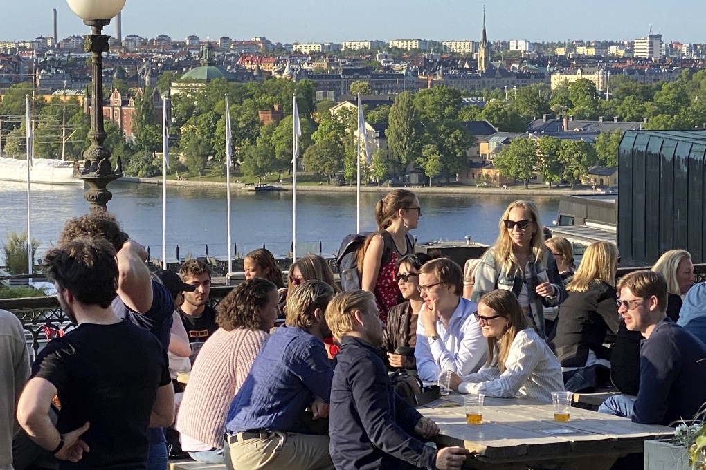 People enjoy drinks and snacks in the evening sun on a terrace overlooking Stockholm. Smoking is prohibited in both indoor and outdoor areas of bars and restaurants in Sweden, which has the lowest share of smokers in the European Union. Photo: AP