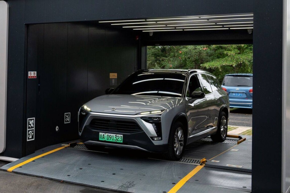 An electric vehicle swaps battery at a Nio battery swapping station in Haikou, on China’s Hainan island, on May 9, 2023. Hainan plans to have EVs and hybrids account for 45 of the island’s fleet by 2030. Photo: Bloomberg