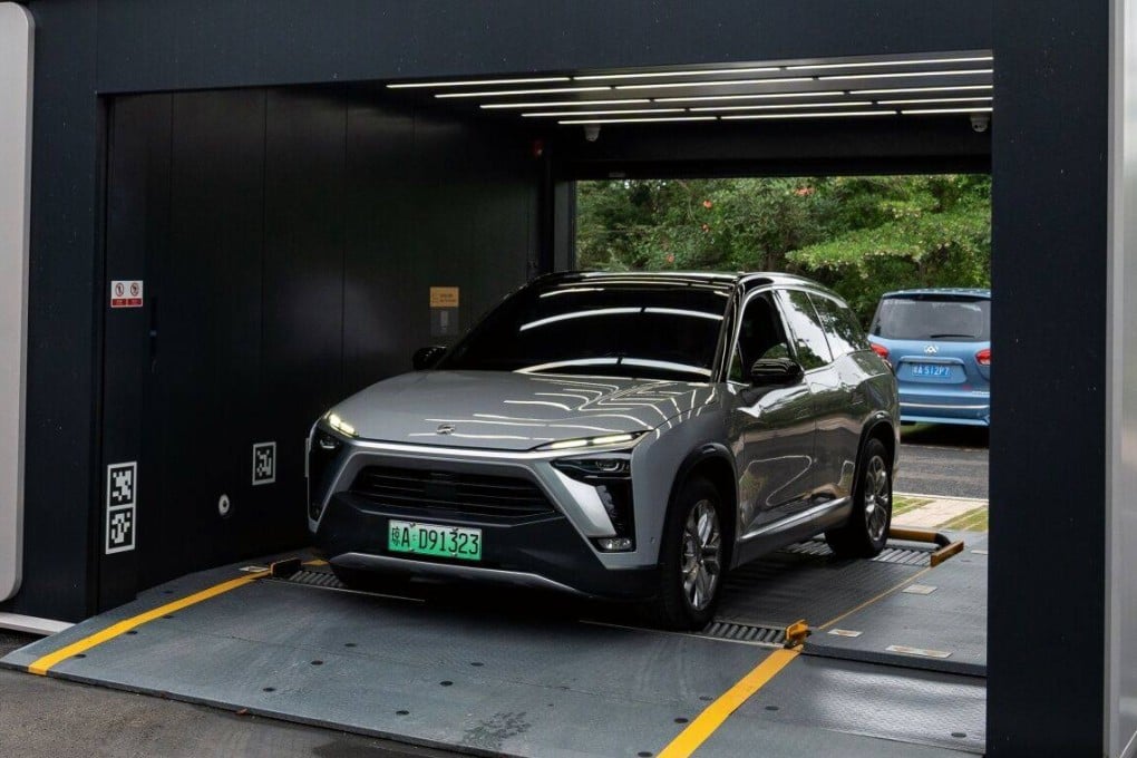 An electric vehicle swaps battery at a Nio battery swapping station in Haikou, on China’s Hainan island, on May 9, 2023. Hainan plans to have EVs and hybrids account for 45 of the island’s fleet by 2030. Photo: Bloomberg