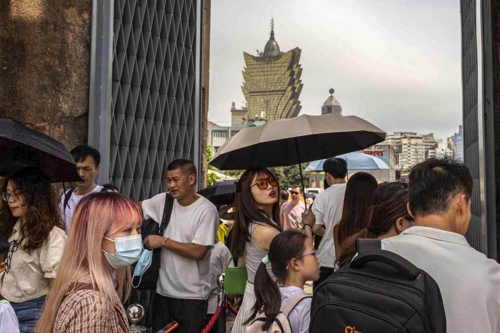 Tourists at the ruins of Saint Paul’s in Macau during the ‘golden week’ holiday in May this year. The latest revenue figures bolster a market consensus that casinos’ earnings are likely to beat expectations this year. Photo: AFP