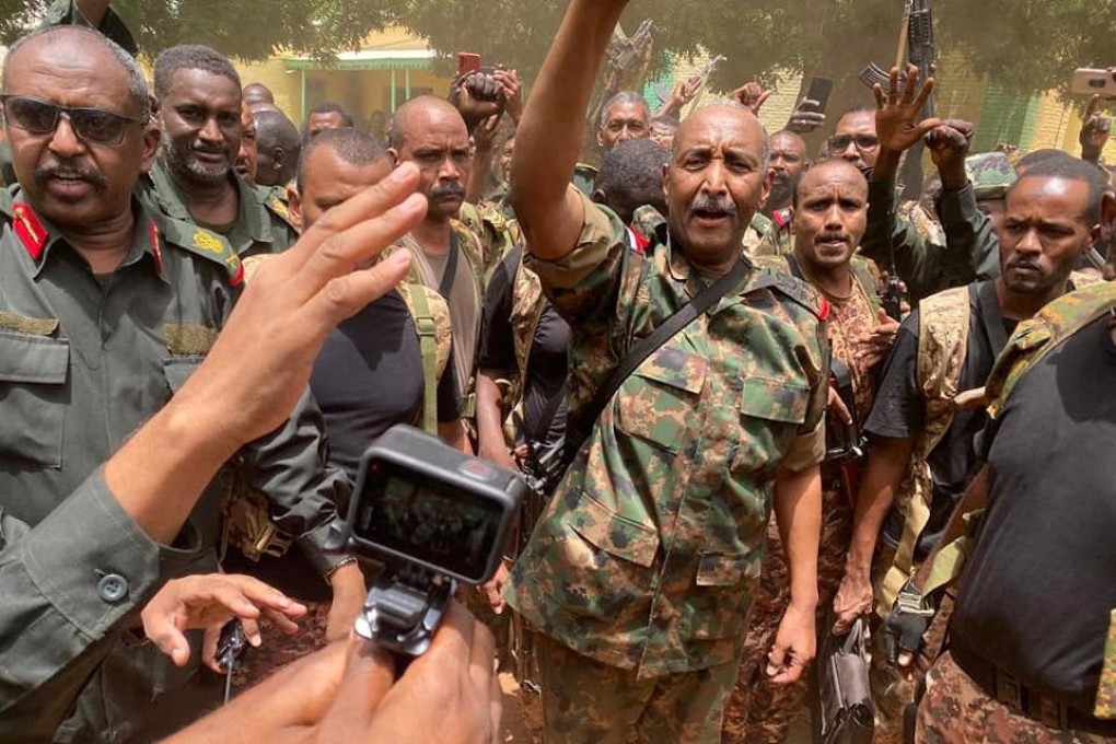 Sudan’s General Abdel Fattah al-Burhan stands among troops at an unknown location, in this picture released on Tuesday. Photo: Sudanese Armed Forces via Reuters