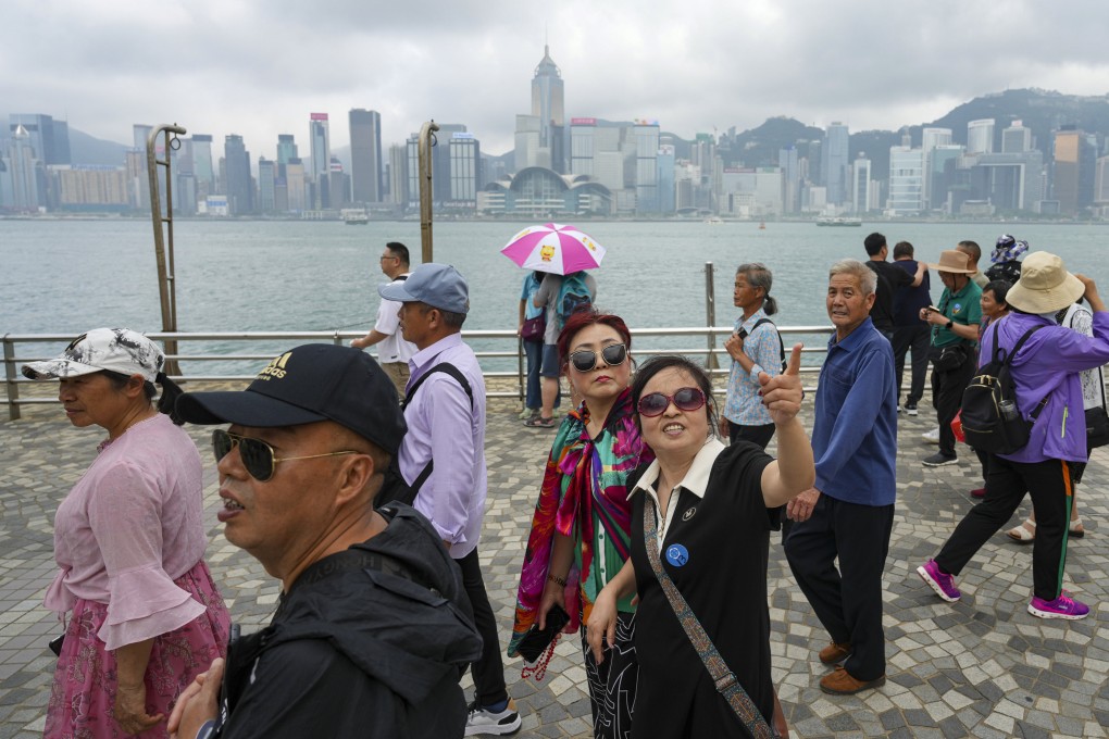 Tourists at Victoria Harbour in Tsim Sha Tsui. Photo: Sam Tsang