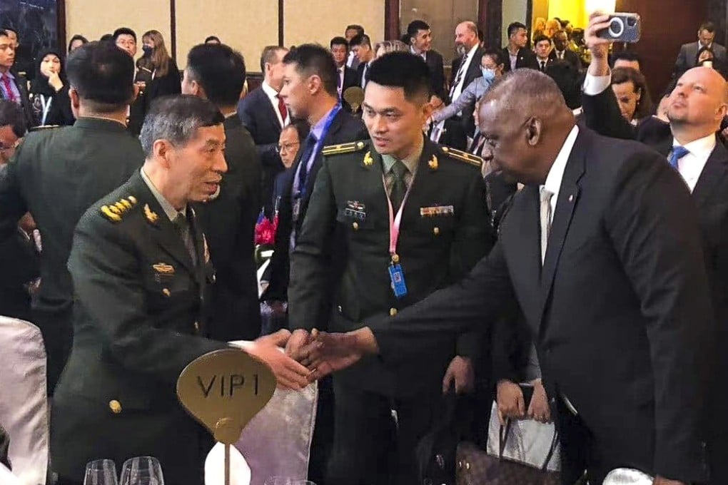 Chinese Defence Minister General Li Shangfu and US Secretary of Defence Lloyd Austin shake hands during the opening dinner for the 20th Shangri-La Dialogue in Singapore on Friday. Photo: Weibo
