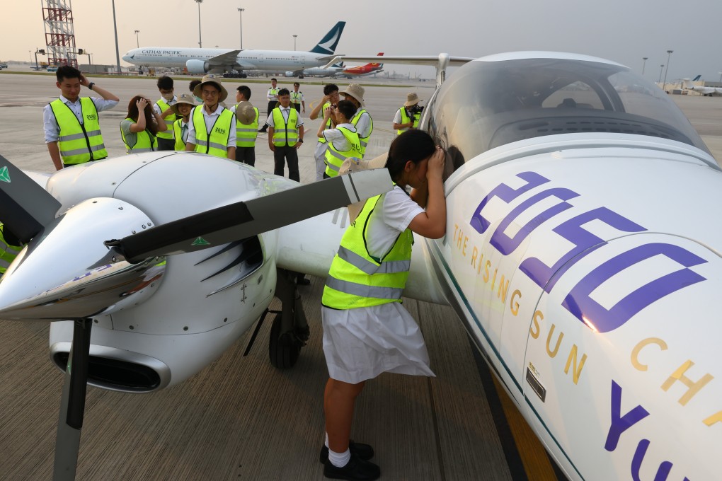 Youngsters from Mu Kuang English School get the chance to examine a Diamond DA42, twin-engined propeller plane, which is on an intercontinental trip to help publicise the “2050” initiative launched by Alibaba Cloud founder Wang Jian. Photo: Dickson Lee