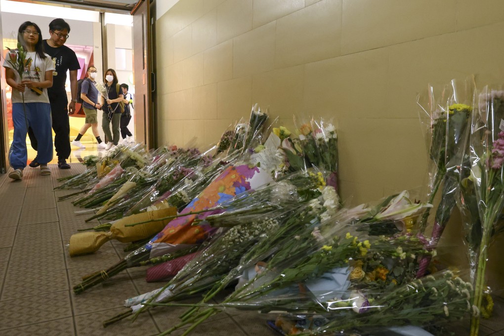 Residents leave flowers near the scene of the attack at Plaza Hollywood in Diamond Hill. Photo: Dickson Lee