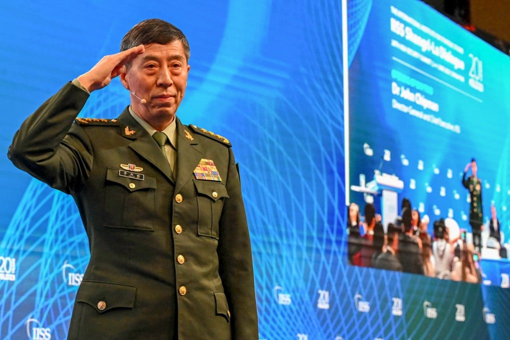 Chinese Defence Minister Li Shangfu salutes the audience before delivering a speech at the Shangri-La Dialogue in Singapore on Sunday. Photo: AFP