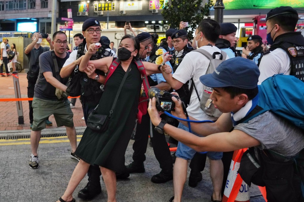 Chan Po-ying, chairwoman of the League of Social Democrats, is taken away by police in Causeway Bay on Sunday. Photo: Elson Li