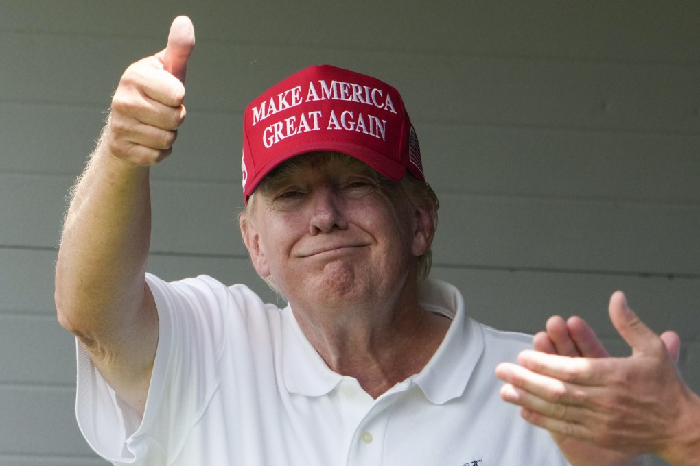 Donald Trump gives a thumbs up as he watches golf with his son Eric at his golf club in the US state of Virginia last month. Photo: AP