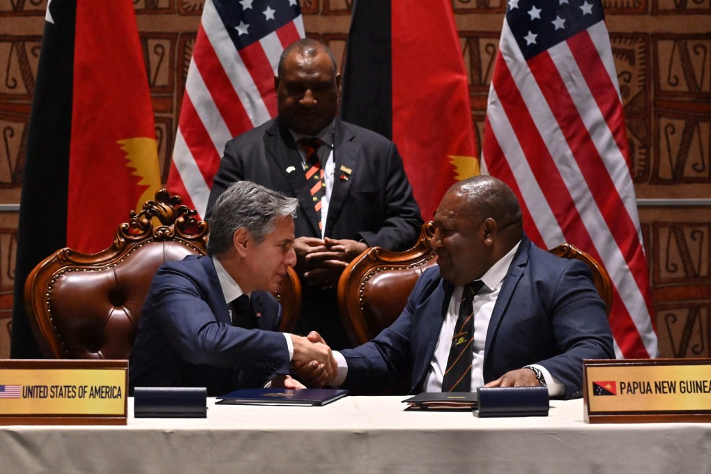 US Secretary of State Antony Blinken (left) and Papua New Guinea Defence Minister Win Bakri Daki shake hands after signing a security agreement as PNG Prime Minister James Marape looks on, in Port Moresby, on May 22. Photo: AFP