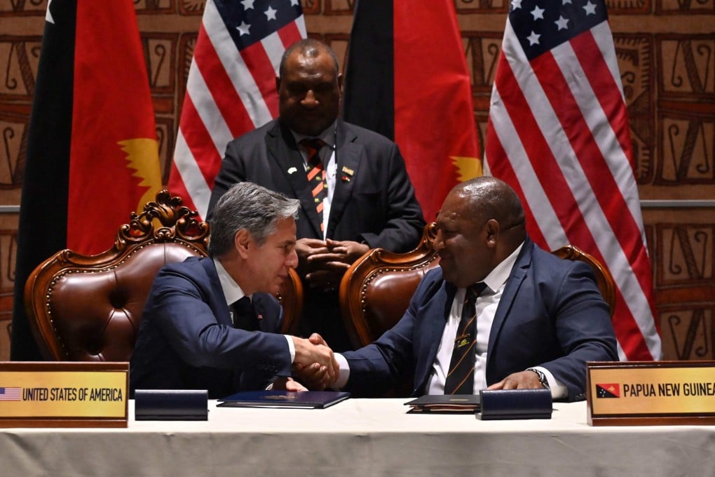 US Secretary of State Antony Blinken (left) and Papua New Guinea Defence Minister Win Bakri Daki shake hands after signing a security agreement as PNG Prime Minister James Marape looks on, in Port Moresby, on May 22. Photo: AFP