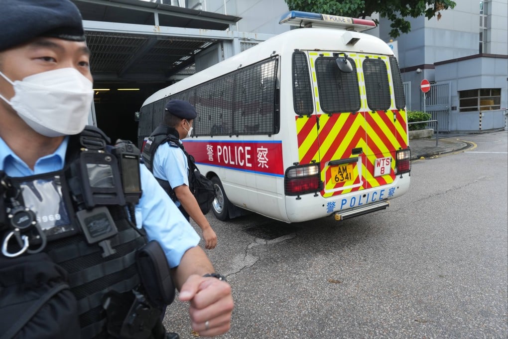 The suspect arrives at Kwun Tong Court on Monday in a police vehicle amid security presence. Photo: Sam Tsang