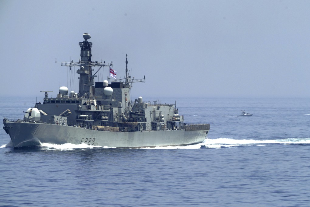 The British frigate HMS Lancaster sails in the Strait of Hormuz last month as Iranian Revolutionary Guard vessels follow behind it. Photo: AP