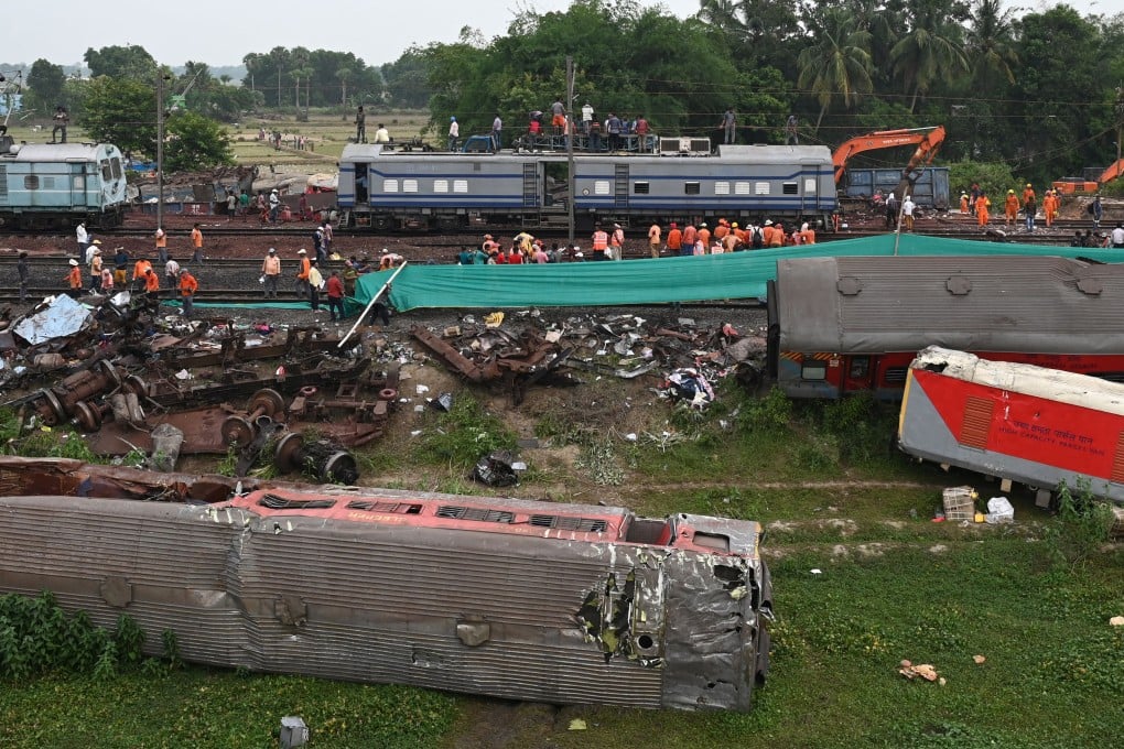 Railway workers help to restore services at the accident site of a three-train collision near Balasore in the eastern state of Odisha, India on Sunday. Photo: AFP via Getty Images / TNS