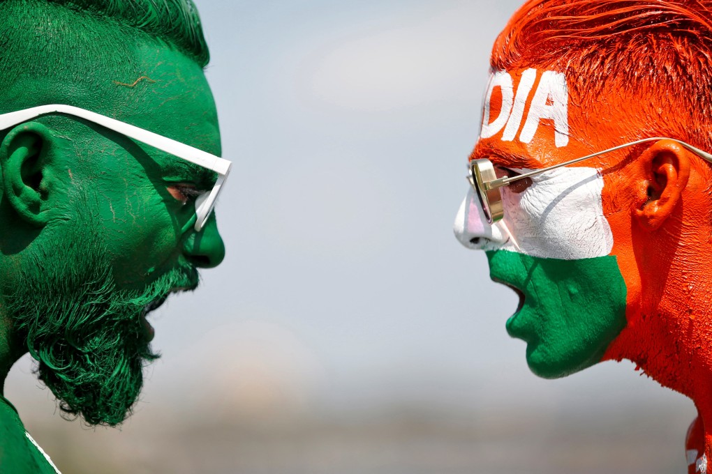 Cricket fans, with their faces painted in the Indian and Pakistani national flag colours, ahead of the first match between India and Pakistan in Twenty20 World Cup super 12 stage on October 23, 2021. Photo: Reuters