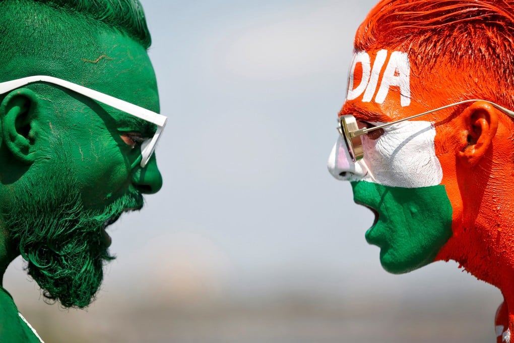 Cricket fans, with their faces painted in the Indian and Pakistani national flag colours, ahead of the first match between India and Pakistan in Twenty20 World Cup super 12 stage on October 23, 2021. Photo: Reuters
