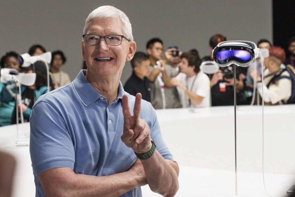 Apple CEO Tim Cook poses next to an Apple Vision Pro AR headset on Monday. Photo: Bloomberg