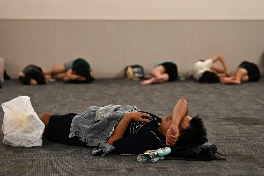 People rest inside a room in a shopping mall set aside for those wanting to escape high outdoor temperatures in Hanoi as parts of northern Vietnam experienced power shortages with rolling outages to cope with increased demand for cooling as the mercury soared. Photo: AFP