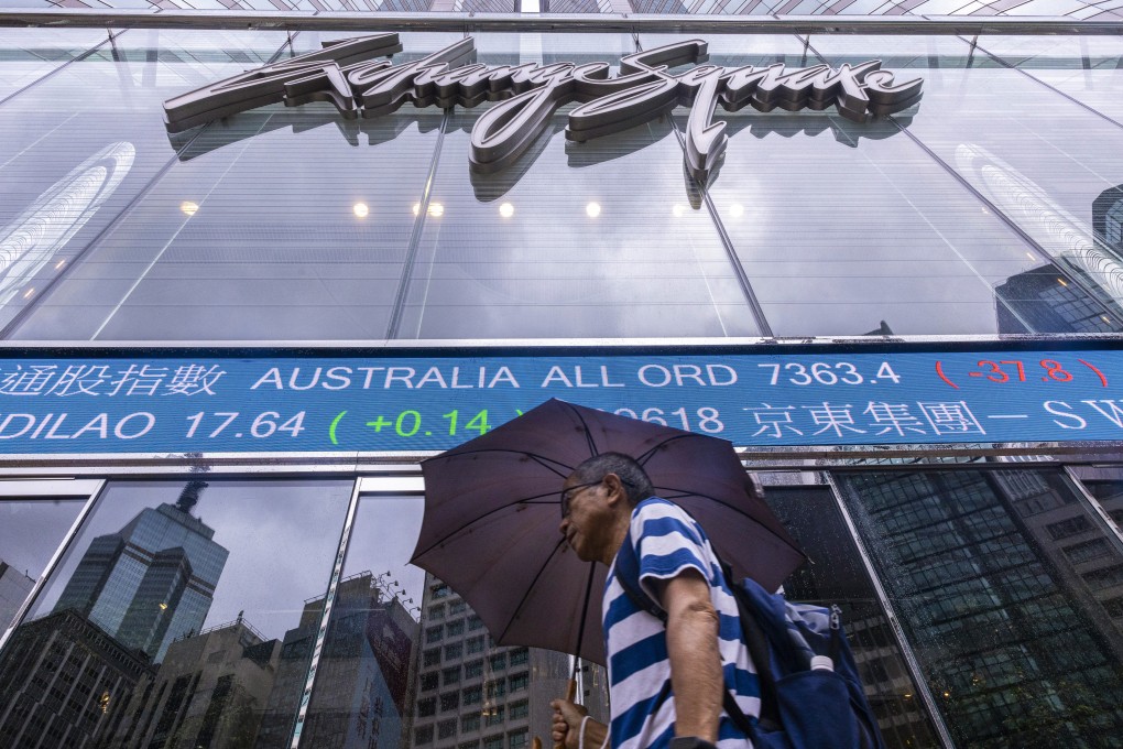 A pedestrian passes by the electronic screen of the Hong Kong stock exchange in Hong Kong on June 6, 2023. Photo: AP