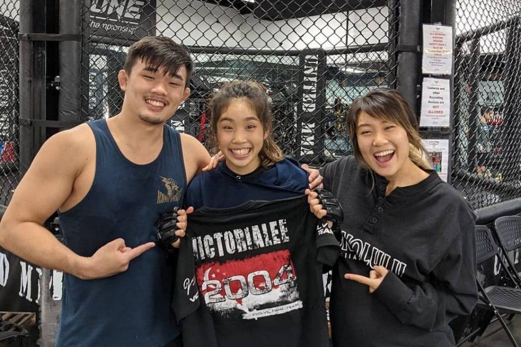 Christan Lee (left) and Angela Lee (right) celebrate with younger sister Victoria Lee after she signs with Evolve MMA. Photo: Instagram