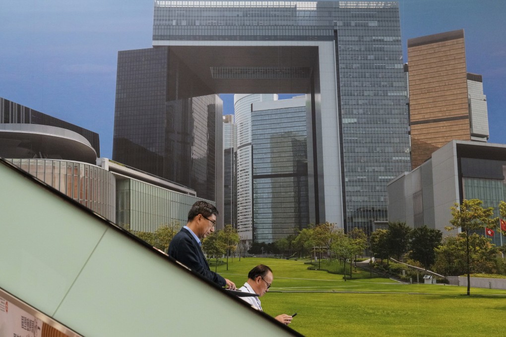 People ride on escalators inside the central government offices building on June 6. The civil service will launch an early recruitment scheme to stem a brain drain. Photo: Elson Li