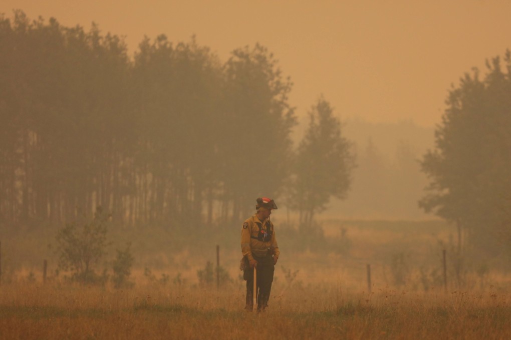 A firefighter in Sturgeon Lake Cree Nation, Alberta, Canada. Photo: Alberta Wildfire via EPA-EFE