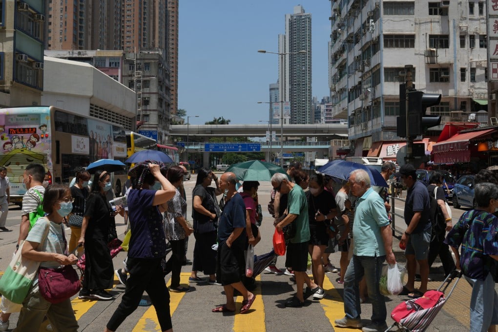 People cross a road near the Mong Kok market in Hong Kong on May 29, 2023. Photo: Sam Tsang
