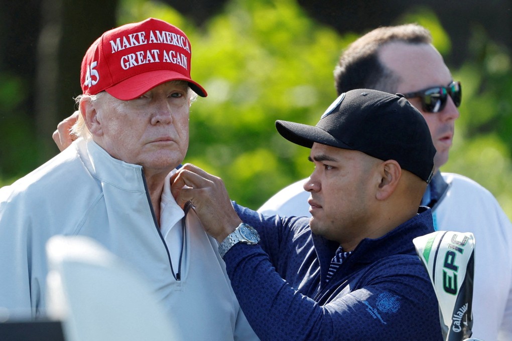 Former US president Donald Trump’s aide Walt Nauta helps his boss with his collar during in the Pro-Am tournament at the Trump National Golf Club in Sterling, Virginia, in May. Photo: Reuters