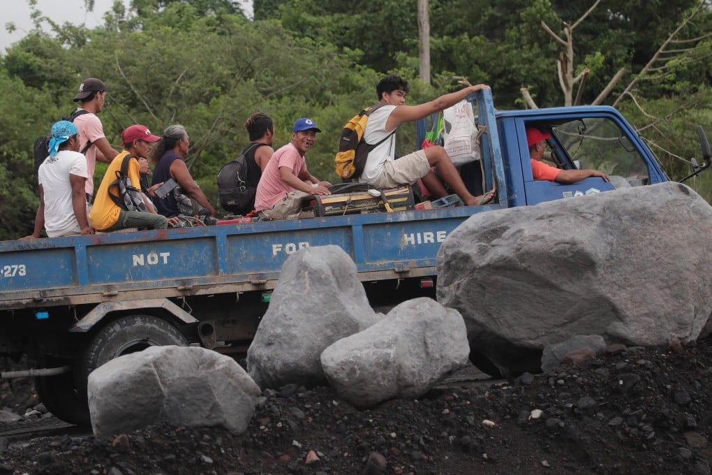 Villagers living in a volcano’s danger zone in the Philippines ride a truck during a mass evacuation in Albay province on Sunday. Photo: EPA-EFE