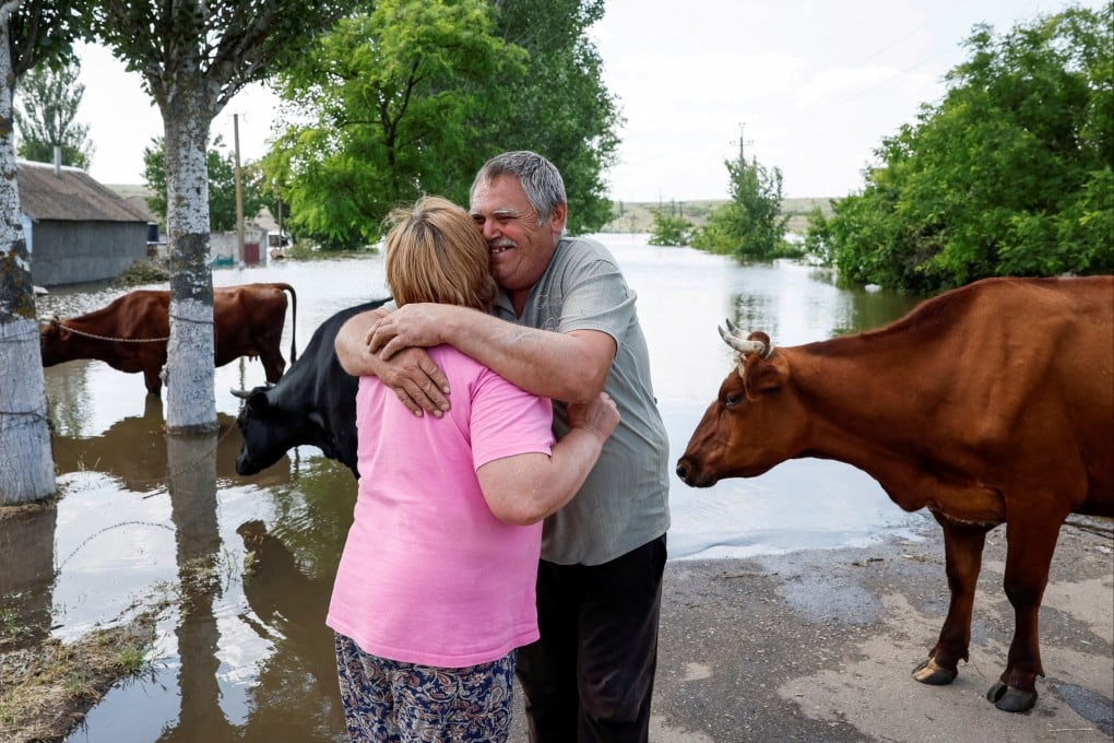 Residents wait for a barge to evacuate their cows from the village of Afanasiivka, which was partly flooded after the Nova Kakhovka dam breached, amid Russia’s attack on Ukraine. Photo: Reuters