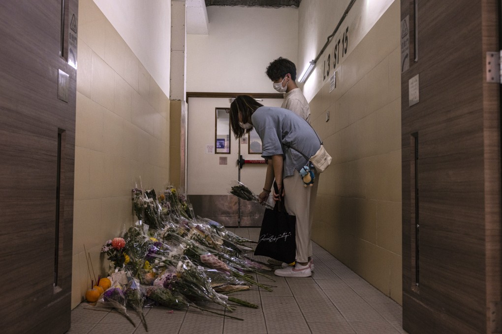 Members of the public pay tribute at the scene of the killing, a day after two persons were stabbed to death at a shopping mall in Hong Kong. Photo: AP