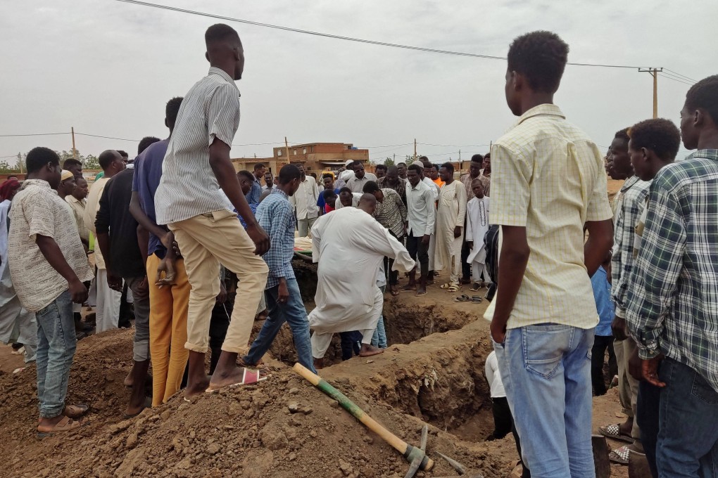 Mourners gather to bury victims killed by an artillery shell strike in southern Khartoum, Sudan on Sunday. Photo: AFP