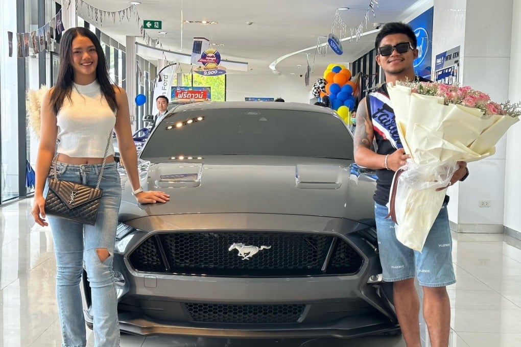 Rodtang Jitmuangnon and his wife Aida Looksaikongdin pose in front of their new Mustang at a car dealership in Bangkok. Photo: Facebook/Rodtang Jitmuangnon