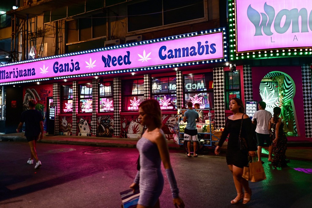 People walk past a cannabis dispensary in the Sukhumvit area of Bangkok. The drug’s decriminalisation has drawn recreational cannabis users to Thailand, but the next government plans to reclassify the drug as a narcotic. Photo: AFP