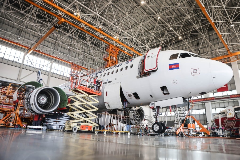 Workers maintain a Cambodia Airways Airbus A320 aeroplane at a hangar in China’s Hainan province. Photo: Xinhua