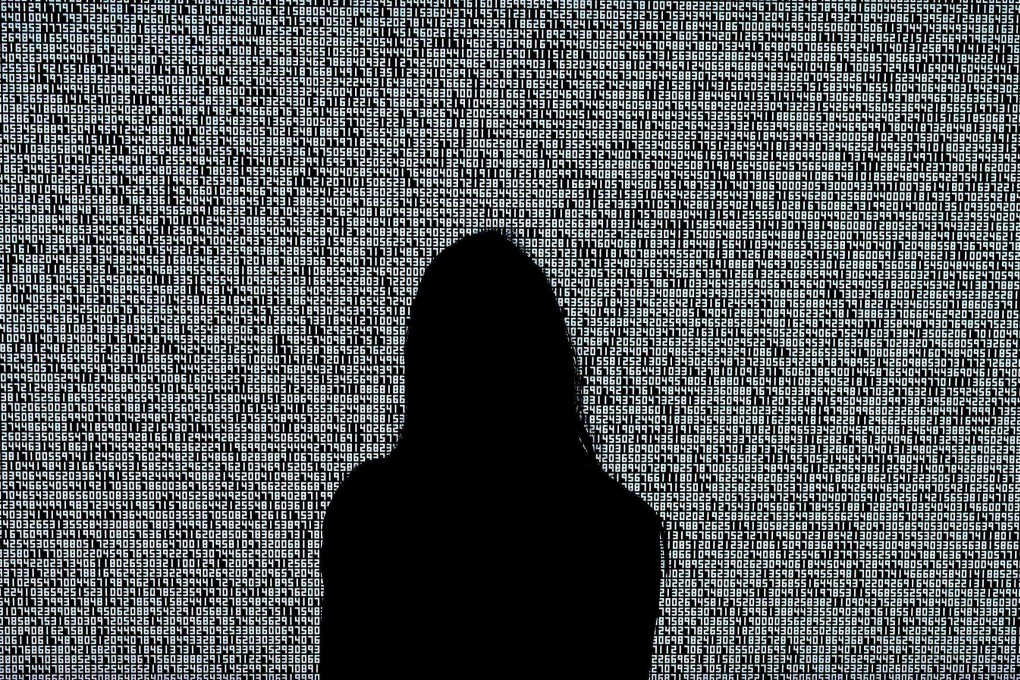 A woman looks at a NFT by Ryoji Ikeda titled “A Single Number That Has 10,000,086 Digits” on June 4, 2021, at Sotheby’s. Photo: AFP