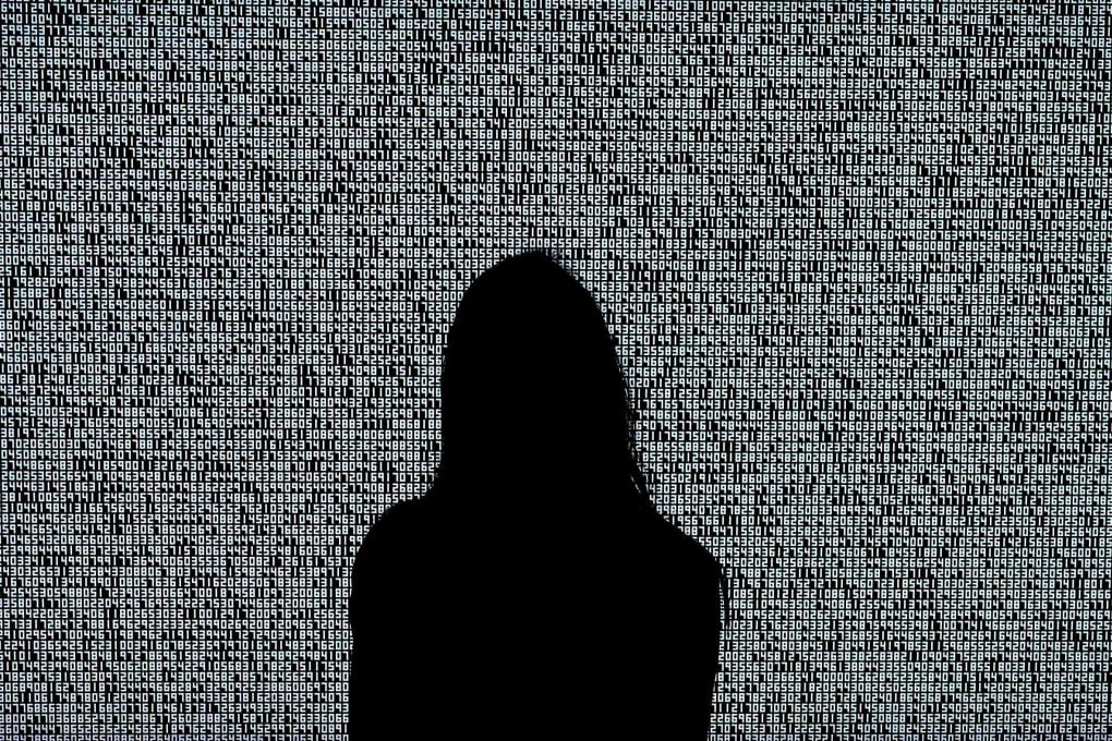A woman looks at a NFT by Ryoji Ikeda titled “A Single Number That Has 10,000,086 Digits” on June 4, 2021, at Sotheby’s. Photo: AFP