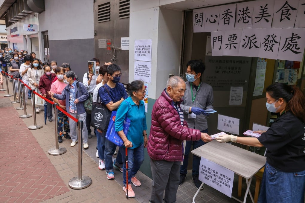 Residents queue up outside at a district office to get their free tickets to a recent food fair. Photo: SCMP/ Dickson Lee