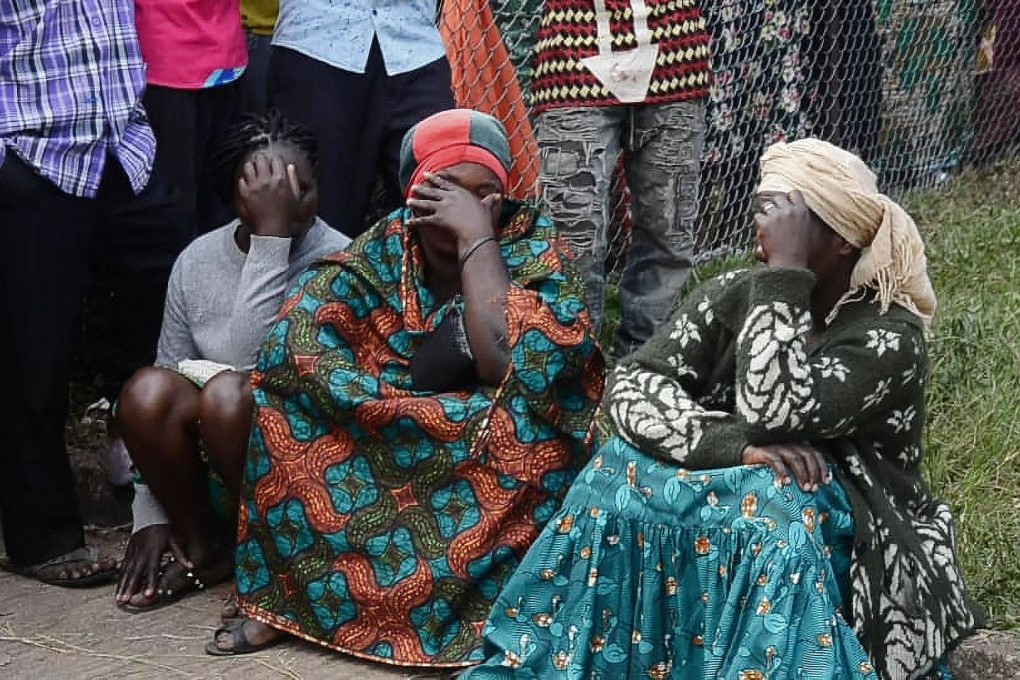 Locals mourn children killed in an attack by militants on a school in western Uganda. Photo: AFP