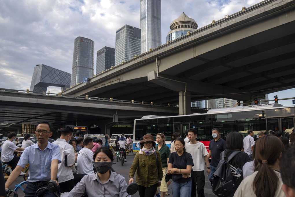 Commuters cross an intersection during the evening rush hour in the central business district of Beijing on June 13. By the count of economist Branko Milanovic, China could have as many rich citizens as the US by around 2040. Photo: AP