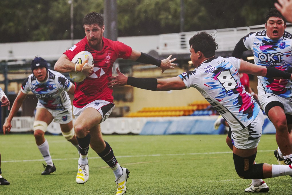 Hong Kong team’s Gregor Mcneish(left) runs with the ball against South Korea. Photos: Edmond So