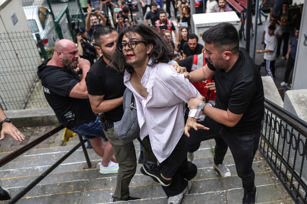Turkish police detain a member of the LGBTQ community in a side street during the Trans Pride march in Istanbul, Turkey on Sunday. Photo: EPA-EFE