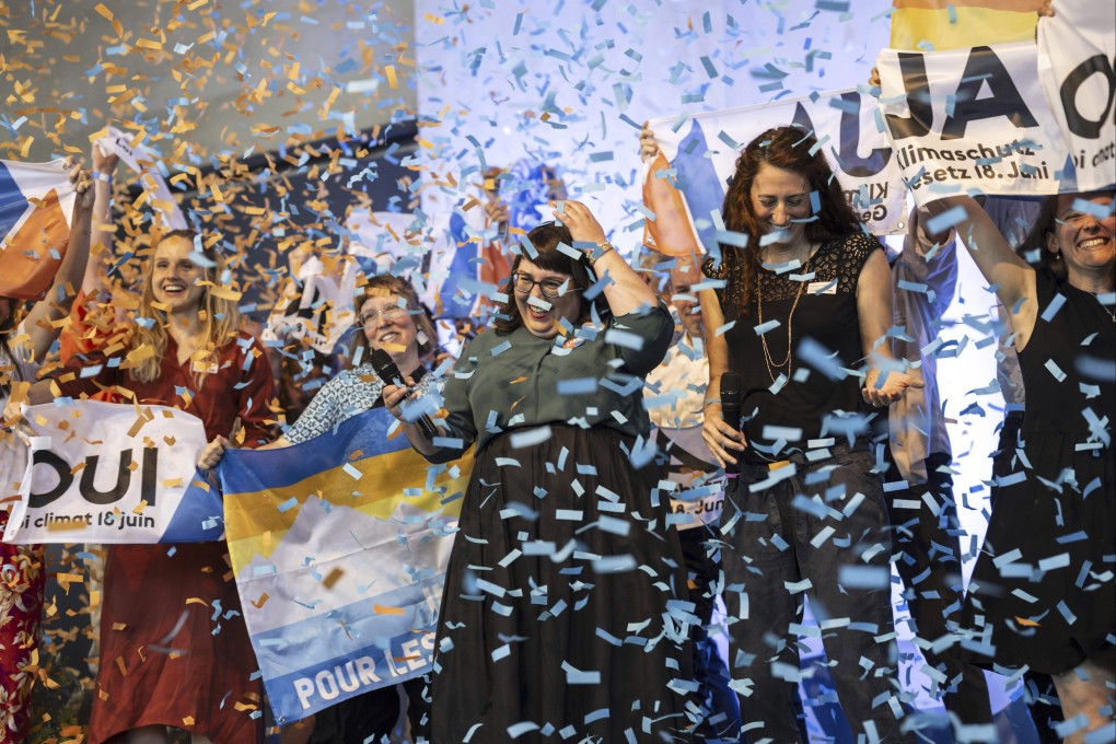 Supporters of the climate change bill throw confetti in Bern, Switzerland on Sunday. Photo: Keystone via AP