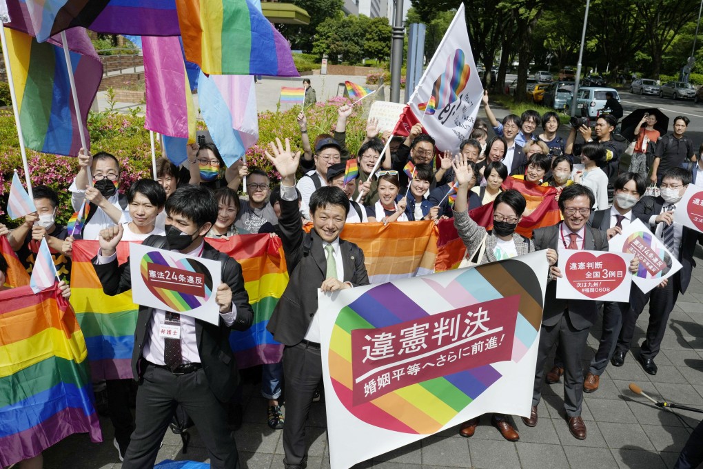 People including plaintiffs’ lawyers hold banners and flags, after the lower court ruled that not allowing same-sex marriage was unconstitutional, outside Nagoya district court in central Japan on May 30. Photo: via Reuters