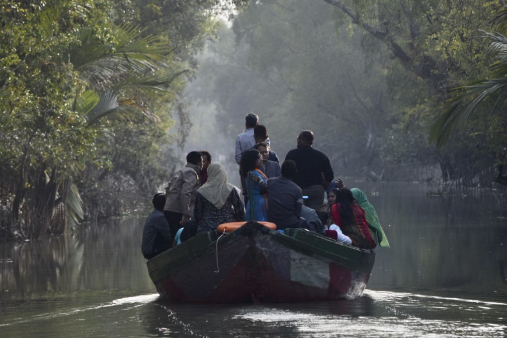 Tourists on a wildlife cruise of the Bangladeshi Sundarbans take smaller wooden boats that give access to the area’s narrow waterways, offering a glimpse into the depths of the mangrove forest. Photo: Victoria Burrows