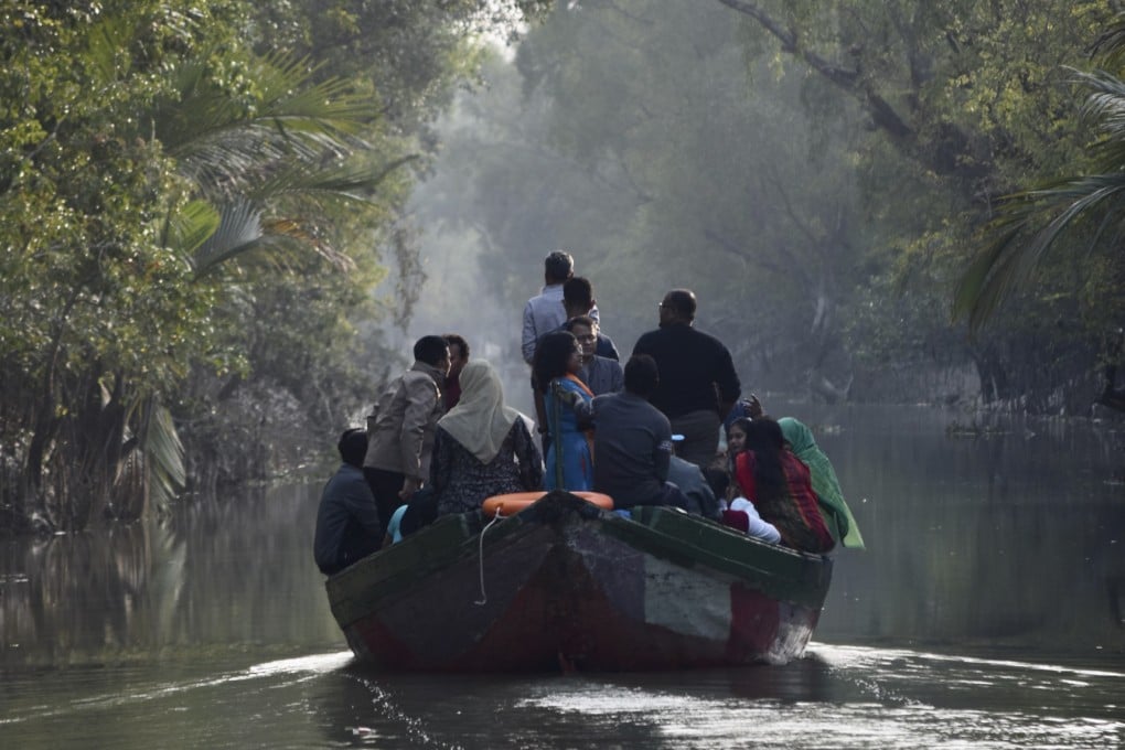 Tourists on a wildlife cruise of the Bangladeshi Sundarbans take smaller wooden boats that give access to the area’s narrow waterways, offering a glimpse into the depths of the mangrove forest. Photo: Victoria Burrows