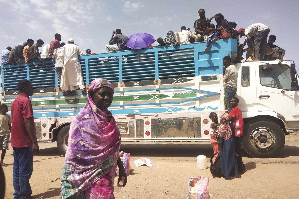 People boarding a truck as they leave Khartoum, Sudan, on Monday. Photo: AP