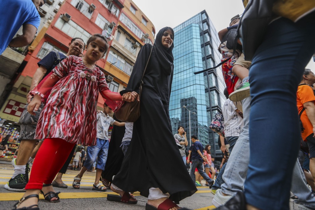 People cross the road in Sham Shui Po, Hong Kong in 2018. All children, irrespective of their ethnicity and cultural background, deserve equal opportunity in education. Photo: Edward Wong