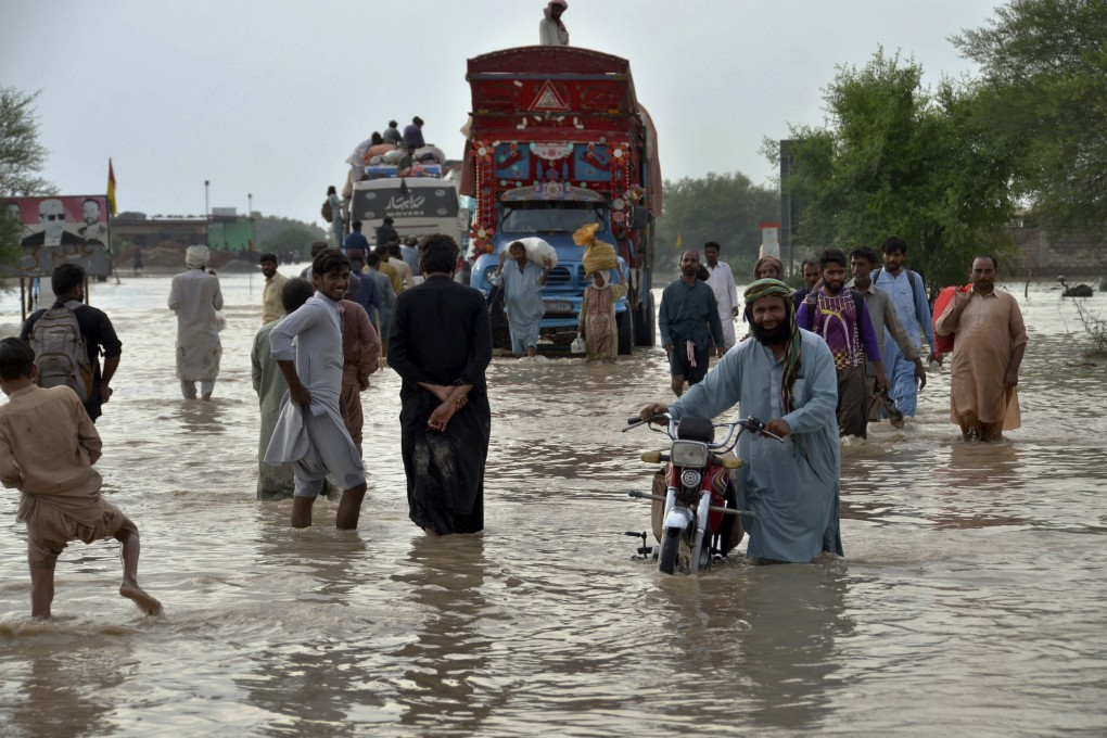 People navigate through a flooded road after heavy monsoon rains in Nasirabad, in Pakistan’s southwestern Baluchistan province, on August 22, 2022. Developing countries need the help of the developed world to mitigate the effects of disasters driven by climate change. Photo: AP