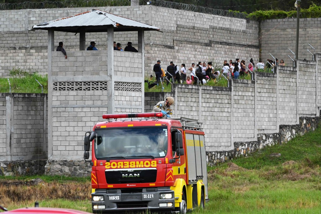 Prison guards watch inmates at the Women’s Centre for Social Adaptation prison in Honduras on Tuesday following a brawl between rival gangs. Photo: AFP